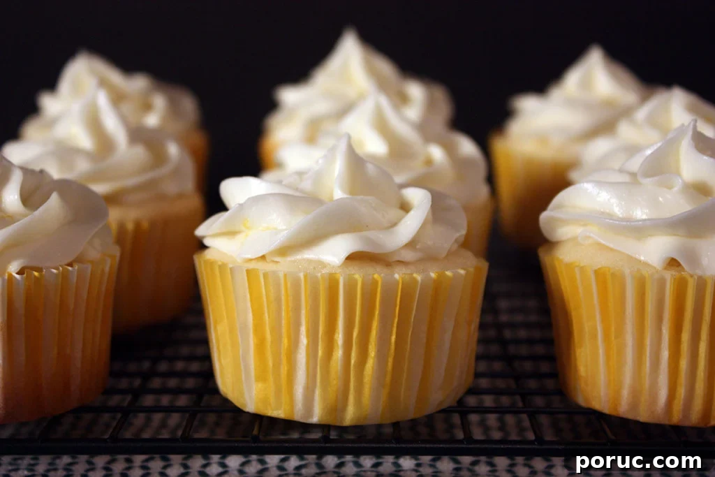 Lemon cupcakes on a wire rack.