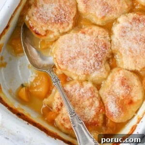 Old Fashioned Peach Cobbler baked vintage spoon serving.