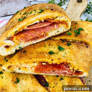Authentic Italian Stromboli Recipe: Crispy, Flavor-Packed Roll 8 Closeup view of Italian Stromboli slices with pepperoni and salami on a wood cutting board.