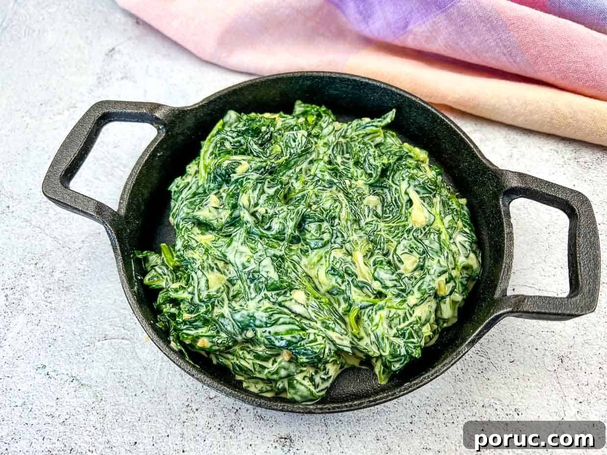 25 Comfort-Food Recipes That Satisfy Every Craving 18 Creamed Spinach with Mascarpone in a black dish.