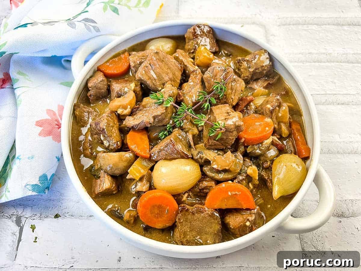 25 Comfort-Food Recipes That Satisfy Every Craving 20 Beef bourguignon in a white bowl with thyme.