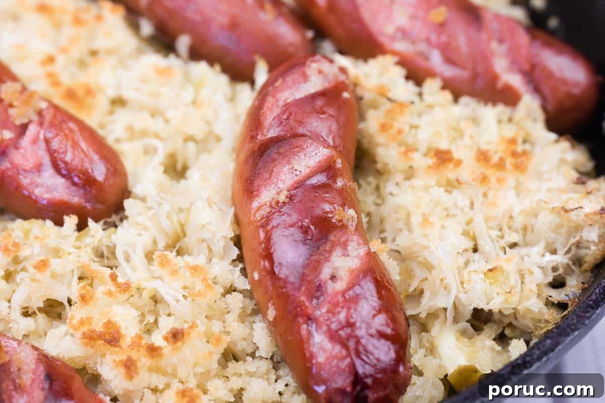 25 Comfort-Food Recipes That Satisfy Every Craving 21 Close-up of browned sausages on a bed of sauerkraut and breadcrumbs in a baking dish.