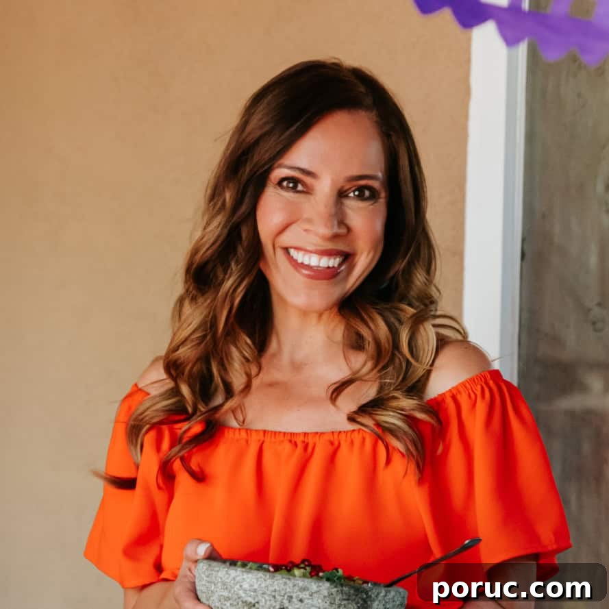 Yvette Marquez-Sharpnack, Mexican cookbook author and founder of Muy Bueno, holding a molcajete and sharing authentic, family-tested Mexican recipes rooted in tradition.