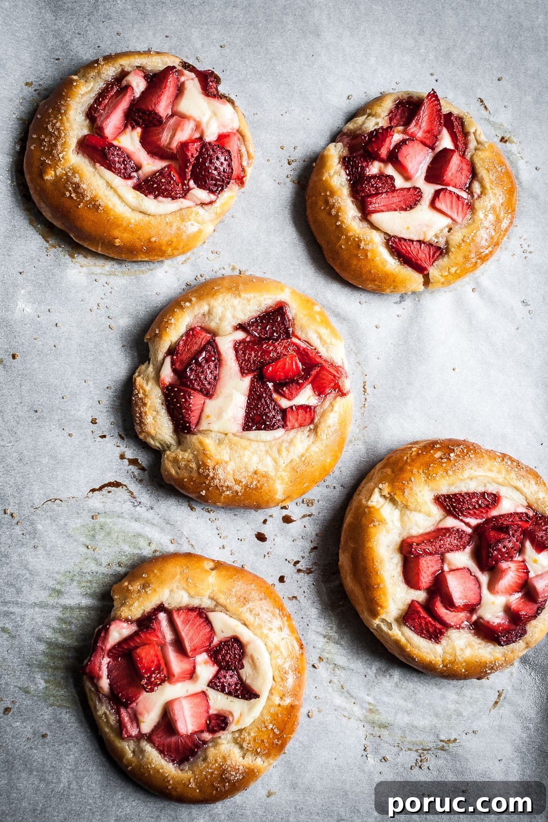 Strawberry Cream Cheese Brioche with Orange Blossom Water 13 Strawberry cream cheese brioche pastries on white parchment after baking