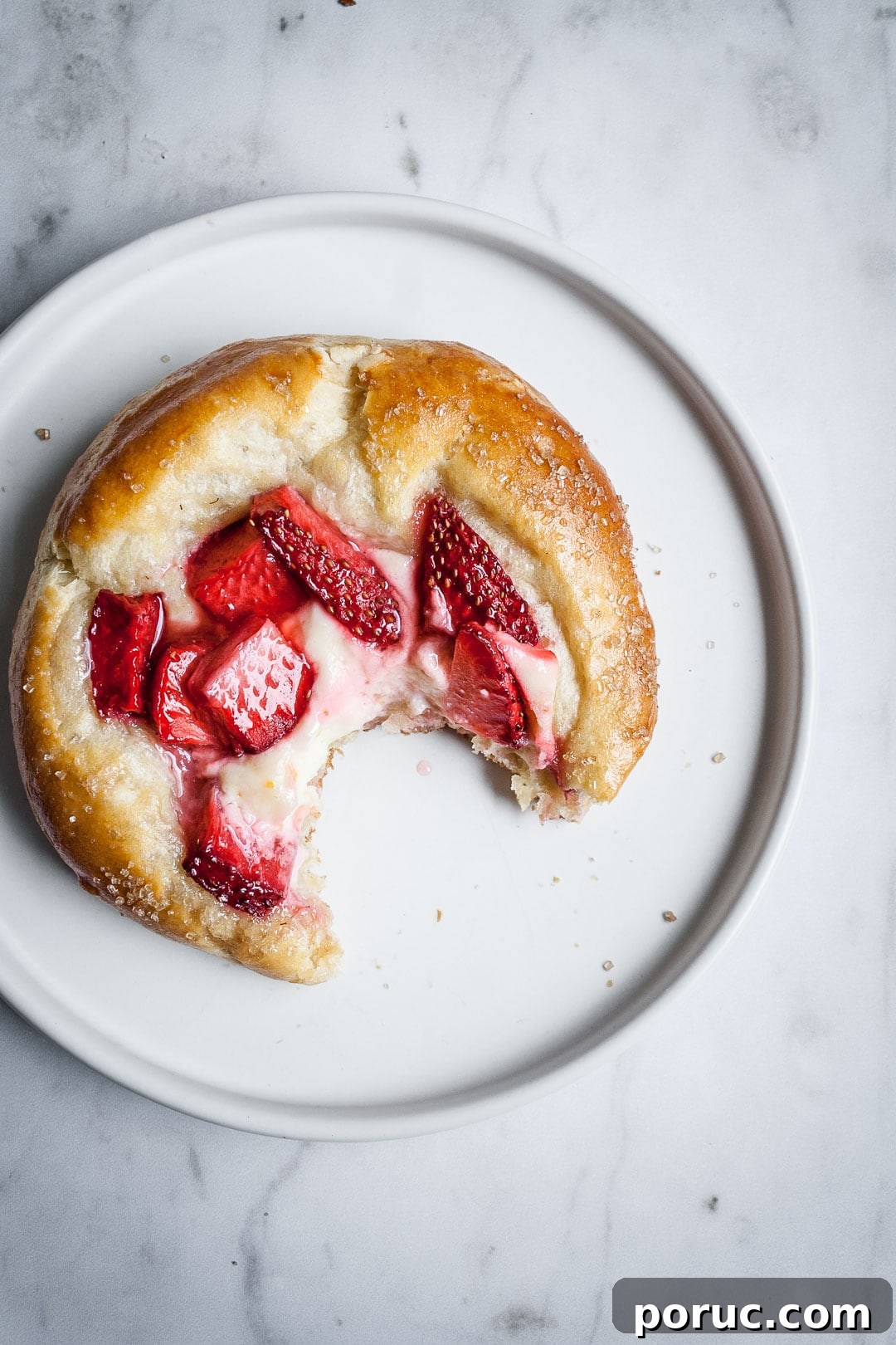 Strawberry Cream Cheese Brioche with Orange Blossom Water 14 Close up of strawberry cream cheese brioche pastry on a white plate and marble background
