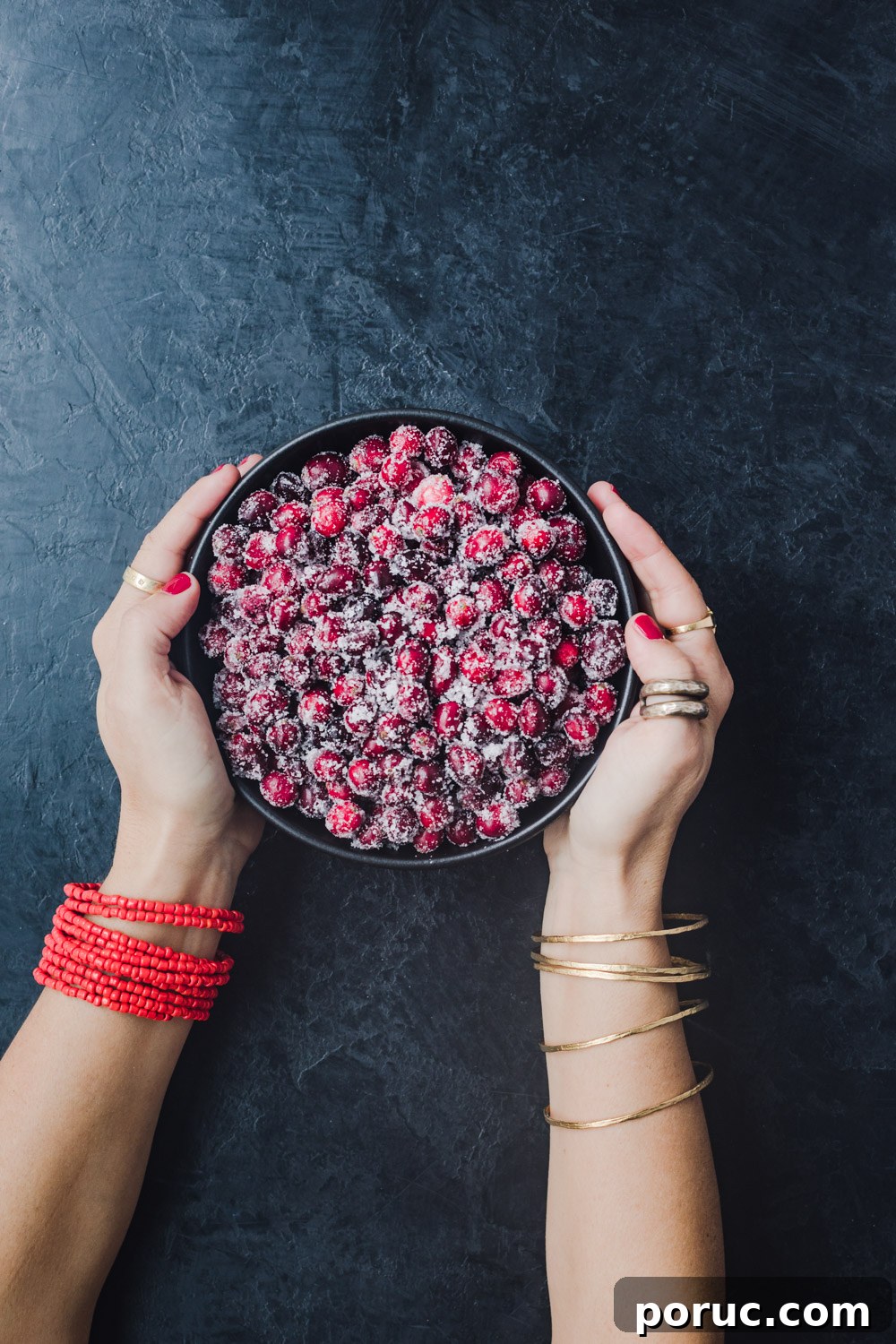 Chef Daniela Gerson holding a bowl filled with sugared cranberries.