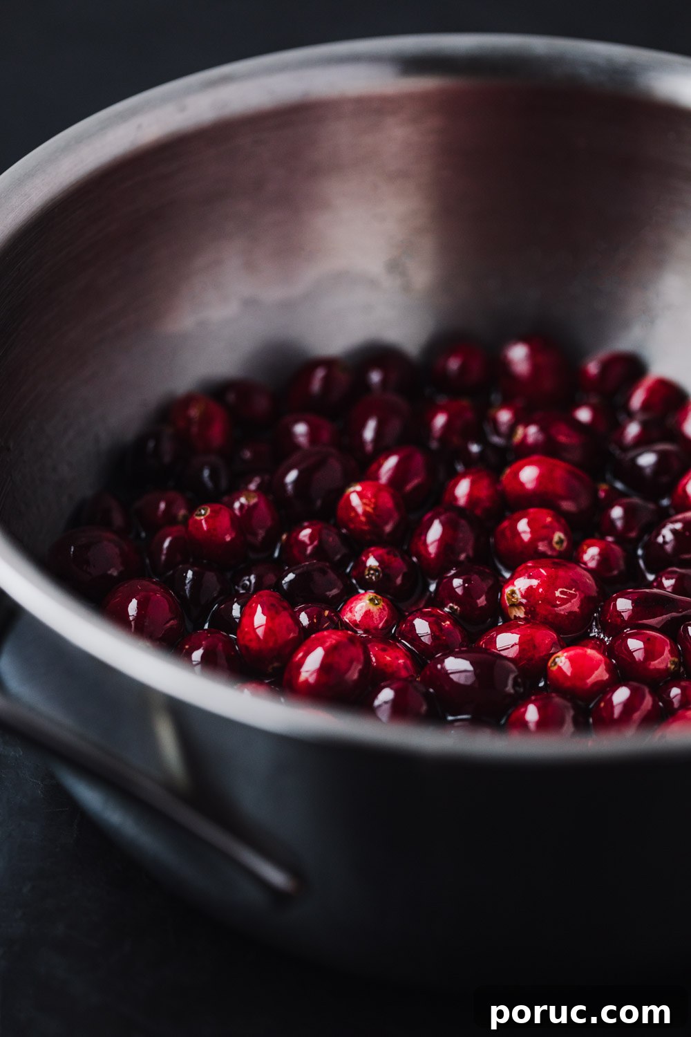 side angle shot of cranberries in simple syrup