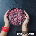 Chef Daniela Gerson holding a bowl filled with sugared cranberries.