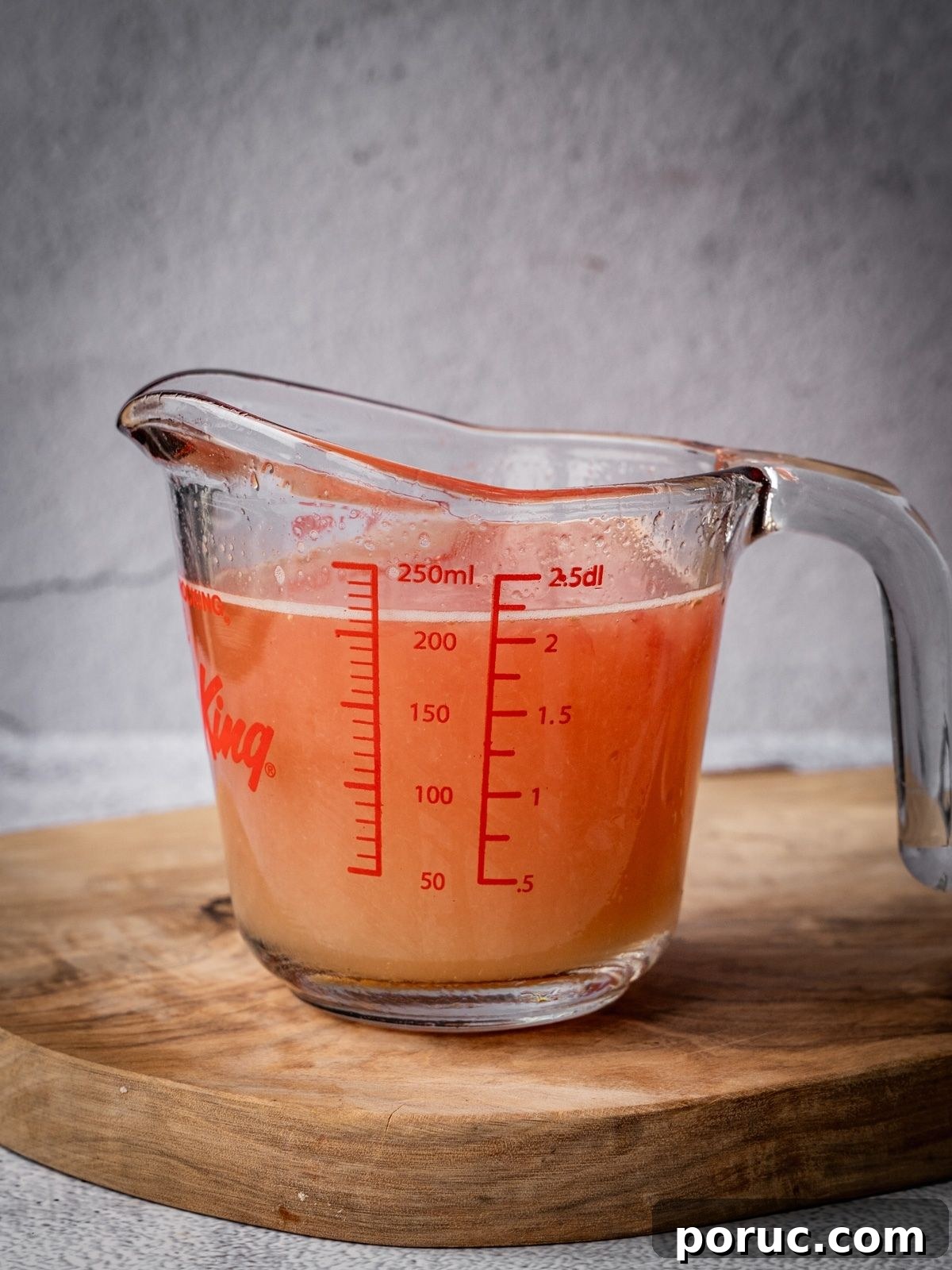 Yucatan-Style Mexican Pickled Red Onions for Tacos & Salads 5 A measuring cup with the juice of limes and grapefruit.