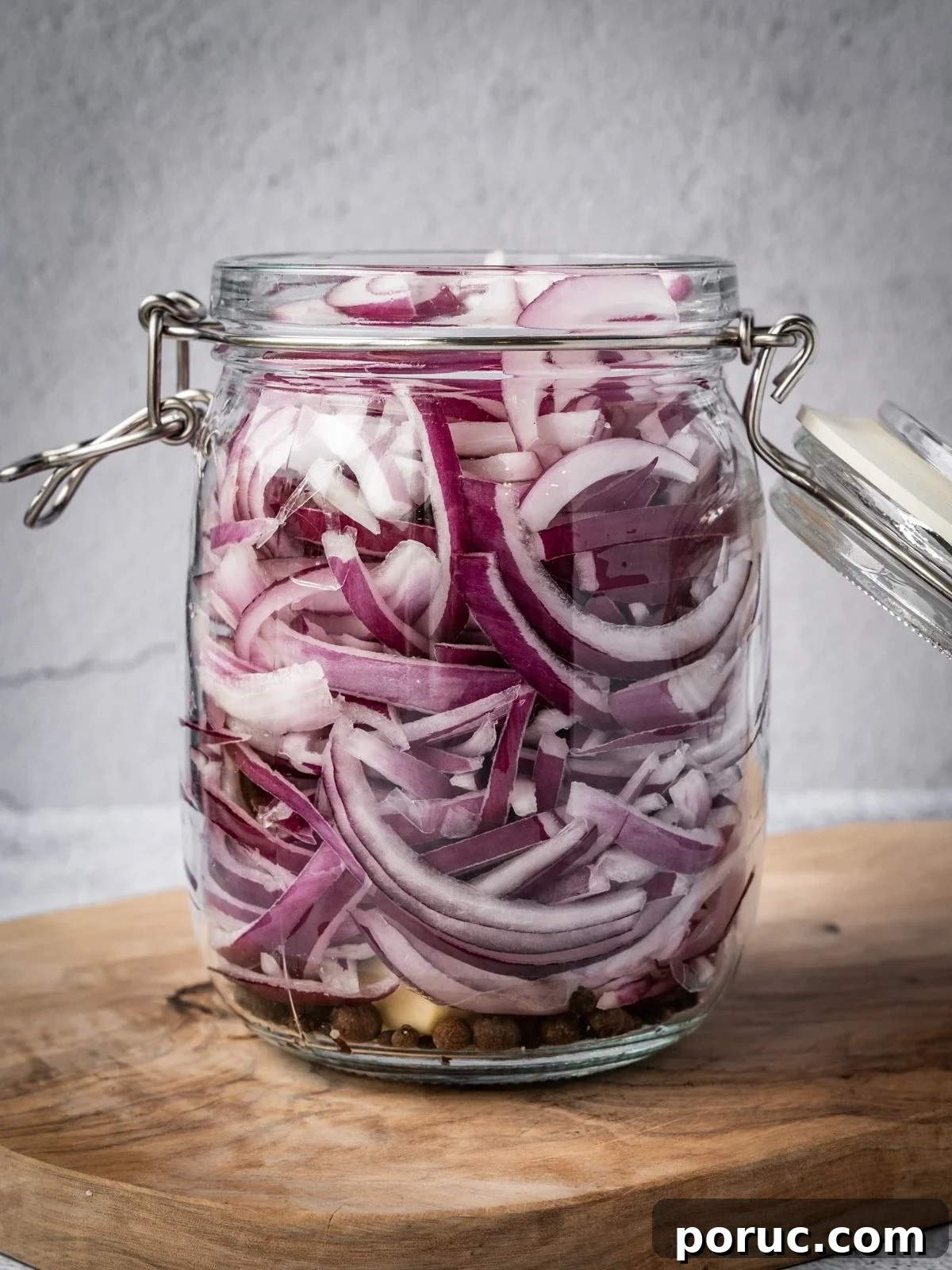 Yucatan-Style Mexican Pickled Red Onions for Tacos & Salads 7 A jar packed with raw sliced onions.