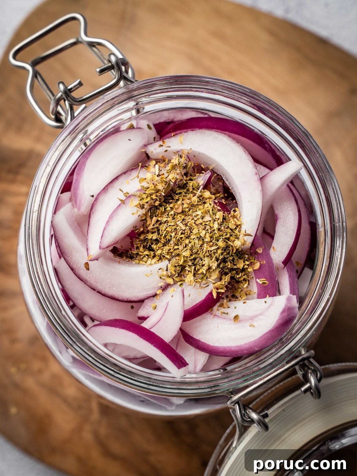 Yucatan-Style Mexican Pickled Red Onions for Tacos & Salads 8 Dried oregano added to the sliced onions in a pickling jar.