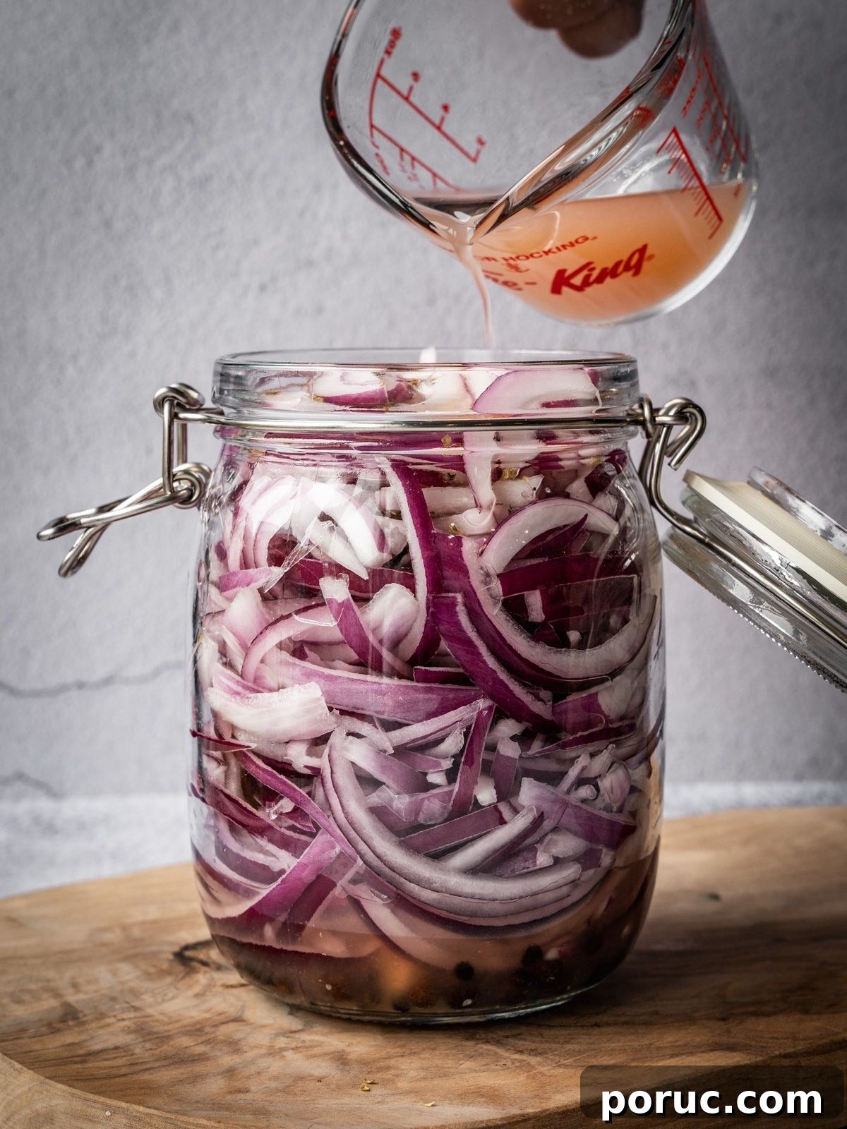 Yucatan-Style Mexican Pickled Red Onions for Tacos & Salads 9 Pouring the citrus juice over the sliced onions.