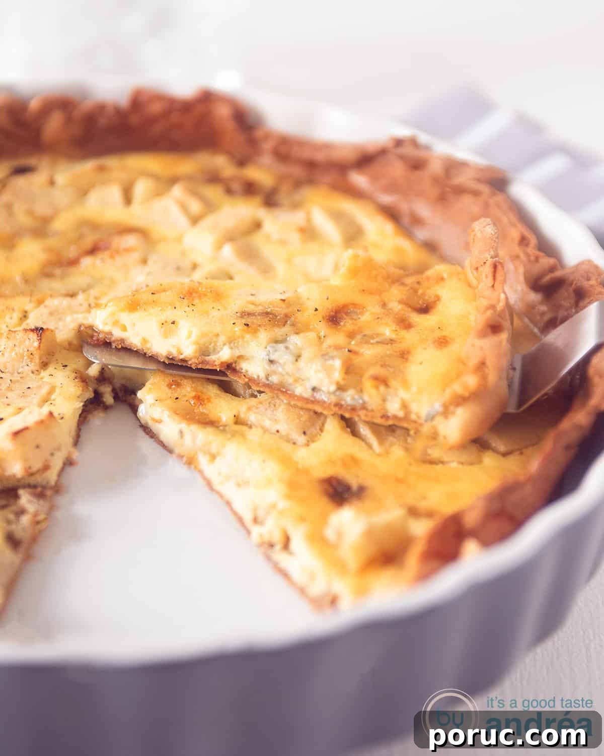 Gorgonzola and Apple Quiche Recipe for Savory Brunch 3 a grey quiche dish with a gorgonzola and apple quiche. A piece laying on top.