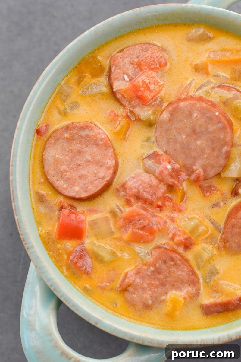 This Cheesy Smoked Sausage Soup is loaded with spicy sausage, tender vegetables in a creamy, cheesy sauce! At less than 7 net carbs per serving this is a great low carb, keto-friendly soup!
