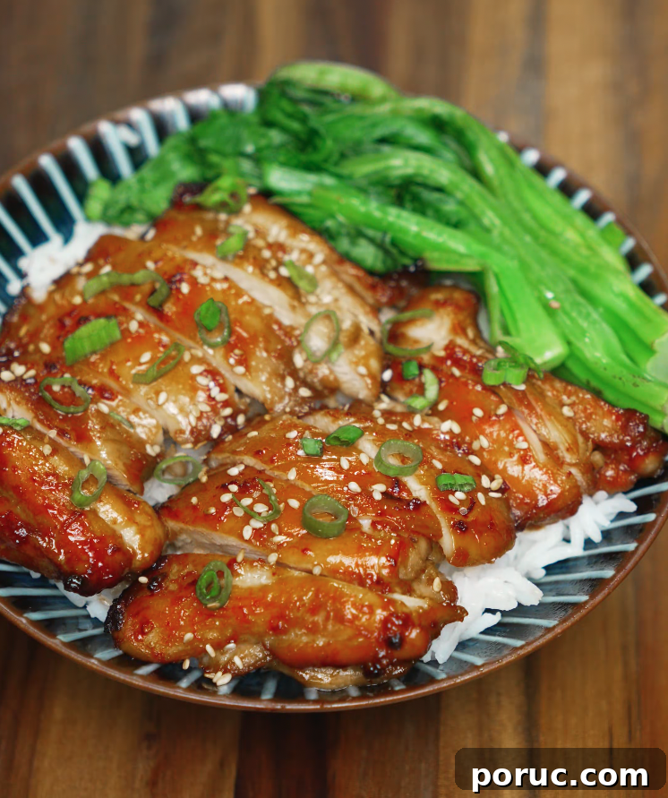 Korean Chicken Bulgogi Recipe: Sweet-Spicy Grilled Chicken 7 Bowl of sliced chicken bulgogi served over steamed rice, topped with sesame seeds and scallions, alongside sautéed greens.