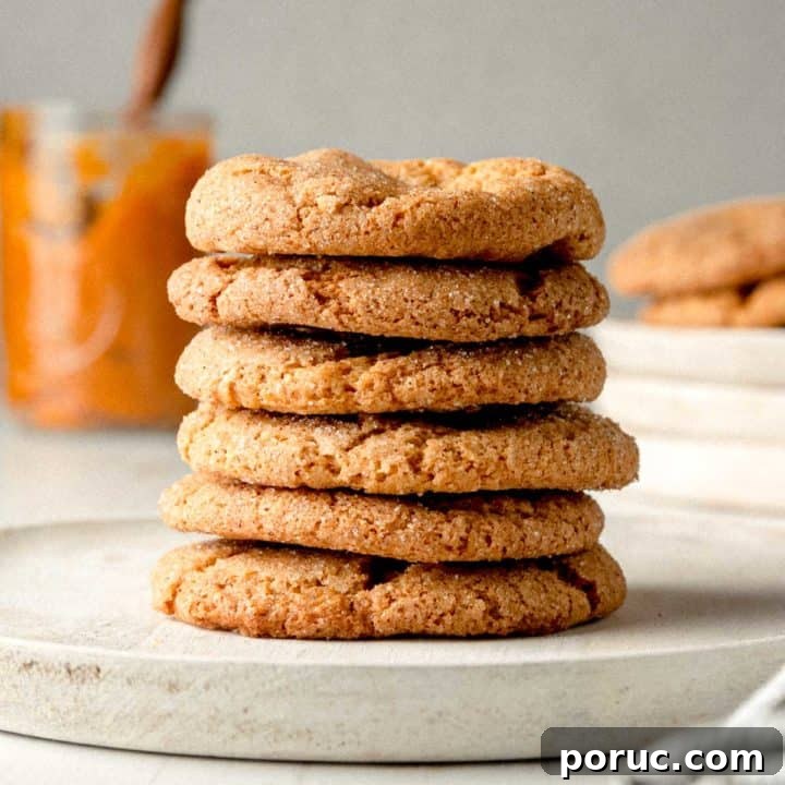 A stack of gluten-free pumpkin cookies on a wooden plate.