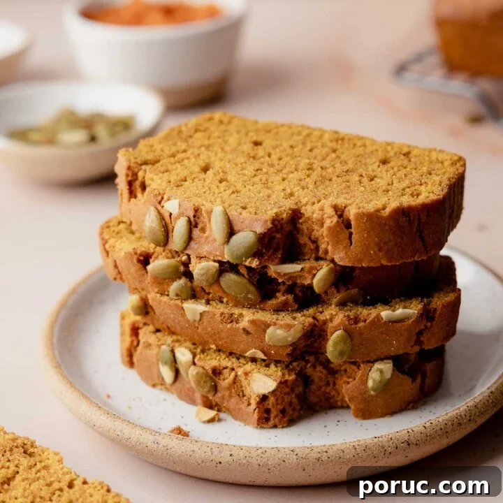 Slices of gluten-free pumpkin bread stacked on small plate.