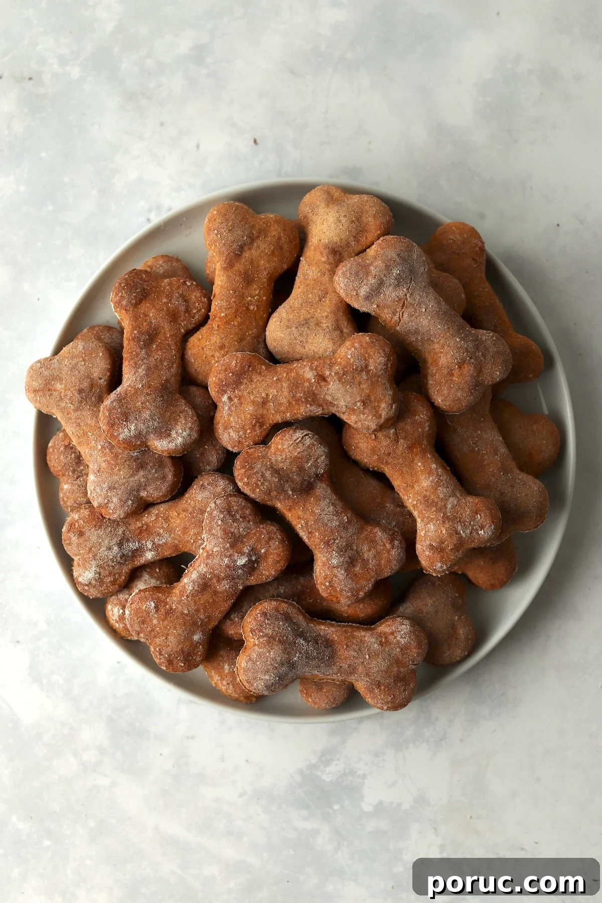 Baked Sweet Potato Dog Treats You Can Make at Home 2 Plate of bone shaped sweet potato dog treats.