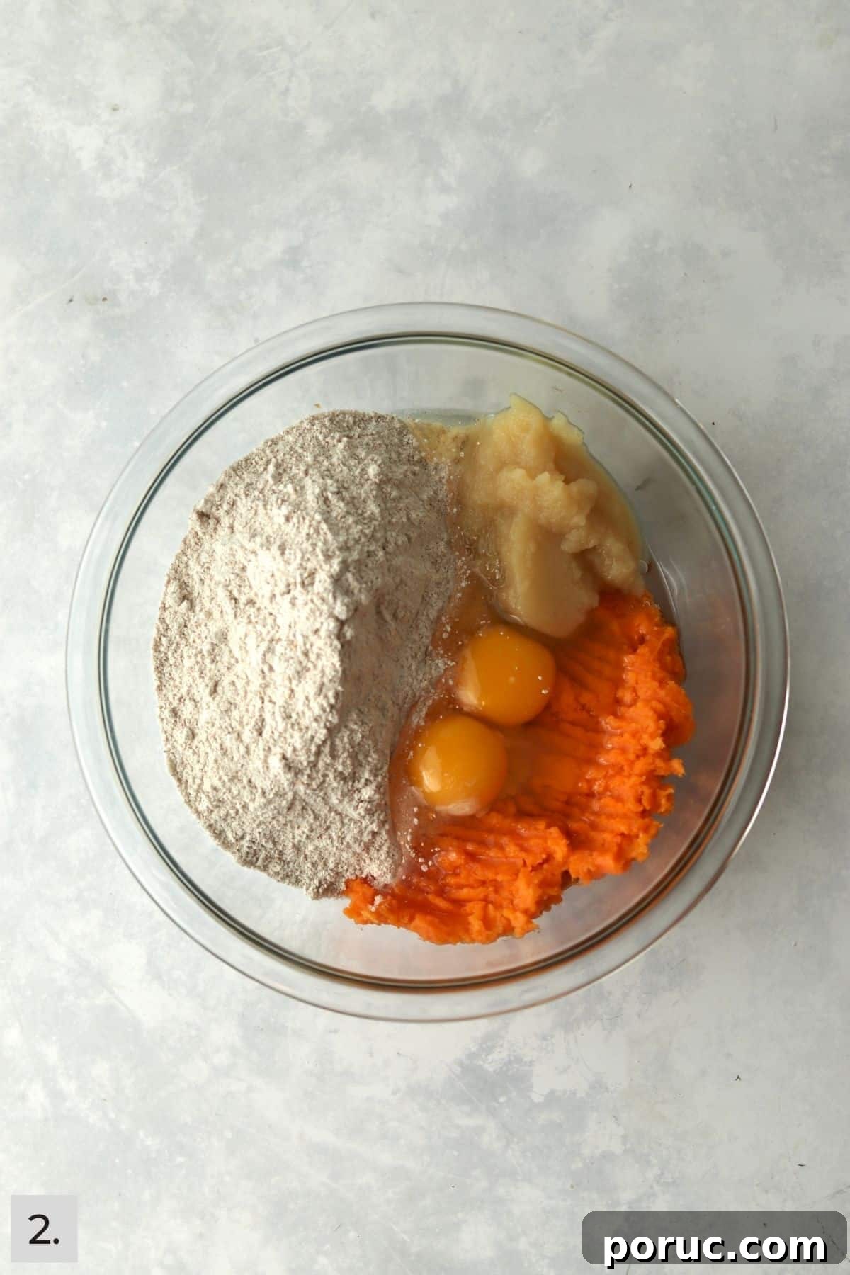 Baked Sweet Potato Dog Treats You Can Make at Home 5 Mashed sweet potato, flour, eggs, and applesauce in a mixing bowl.