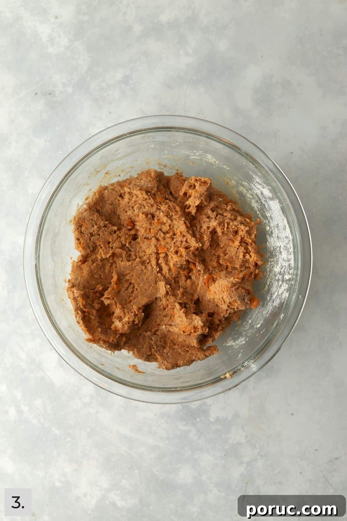 Baked Sweet Potato Dog Treats You Can Make at Home 6 Sweet potato dog treat dough in a glass mixing bowl.