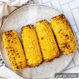 Grilled Corn on the Cob: 3 Quick Methods in 20 Minutes 12 The best grilled corn on the cob recipe, beautifully presented on a plate.