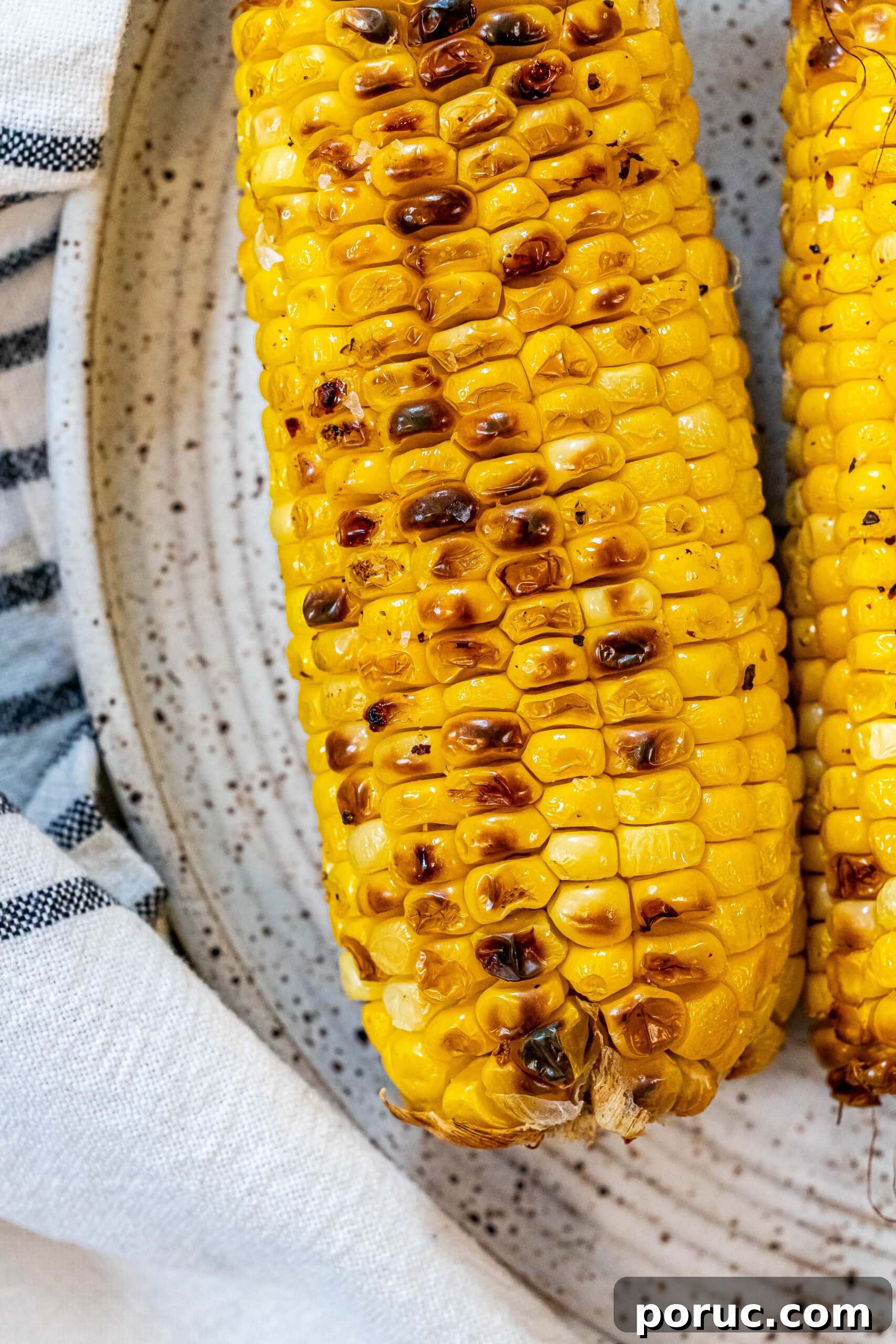 Grilled Corn on the Cob: 3 Quick Methods in 20 Minutes 7 charred corn on the cob on a plate