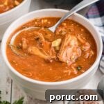 Authentic Louisiana Turtle Soup Recipe – Classic Creole Flavor 9 A bowl of Louisiana turtle soup with a spoon digging in, cropped square.
