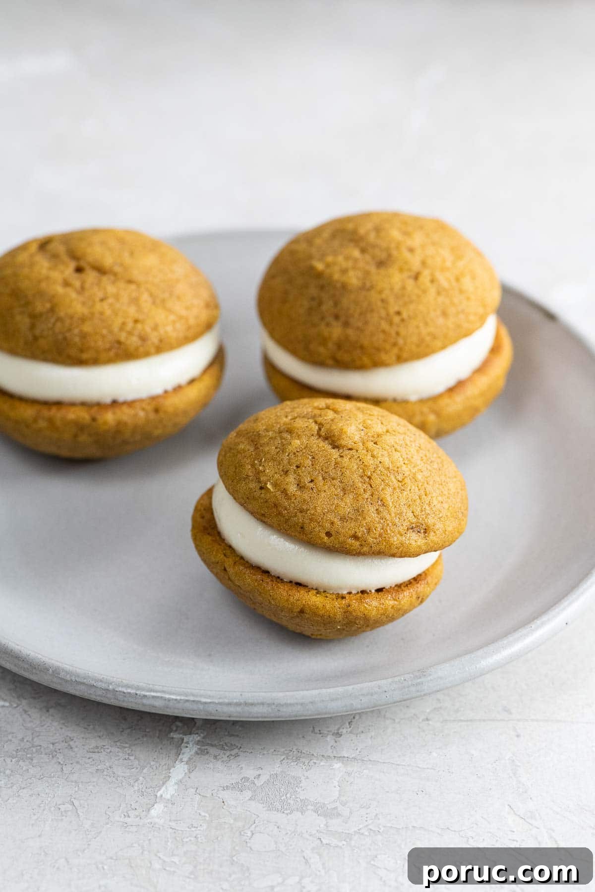 Mini Pumpkin Whoopie Pies with Cream Cheese Filling — Fall Dessert Recipe 2 mini pumpkin whoopie pies on a small plate