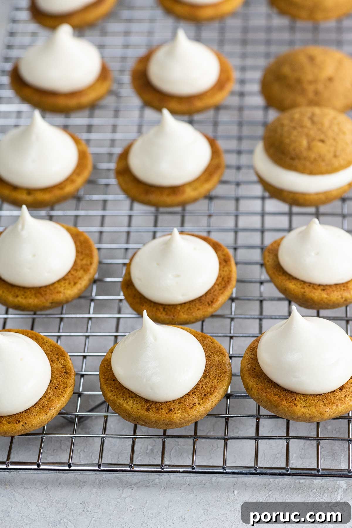 Mini Pumpkin Whoopie Pies with Cream Cheese Filling — Fall Dessert Recipe 6 mini pumpkin whoopie pies on a cooling rack
