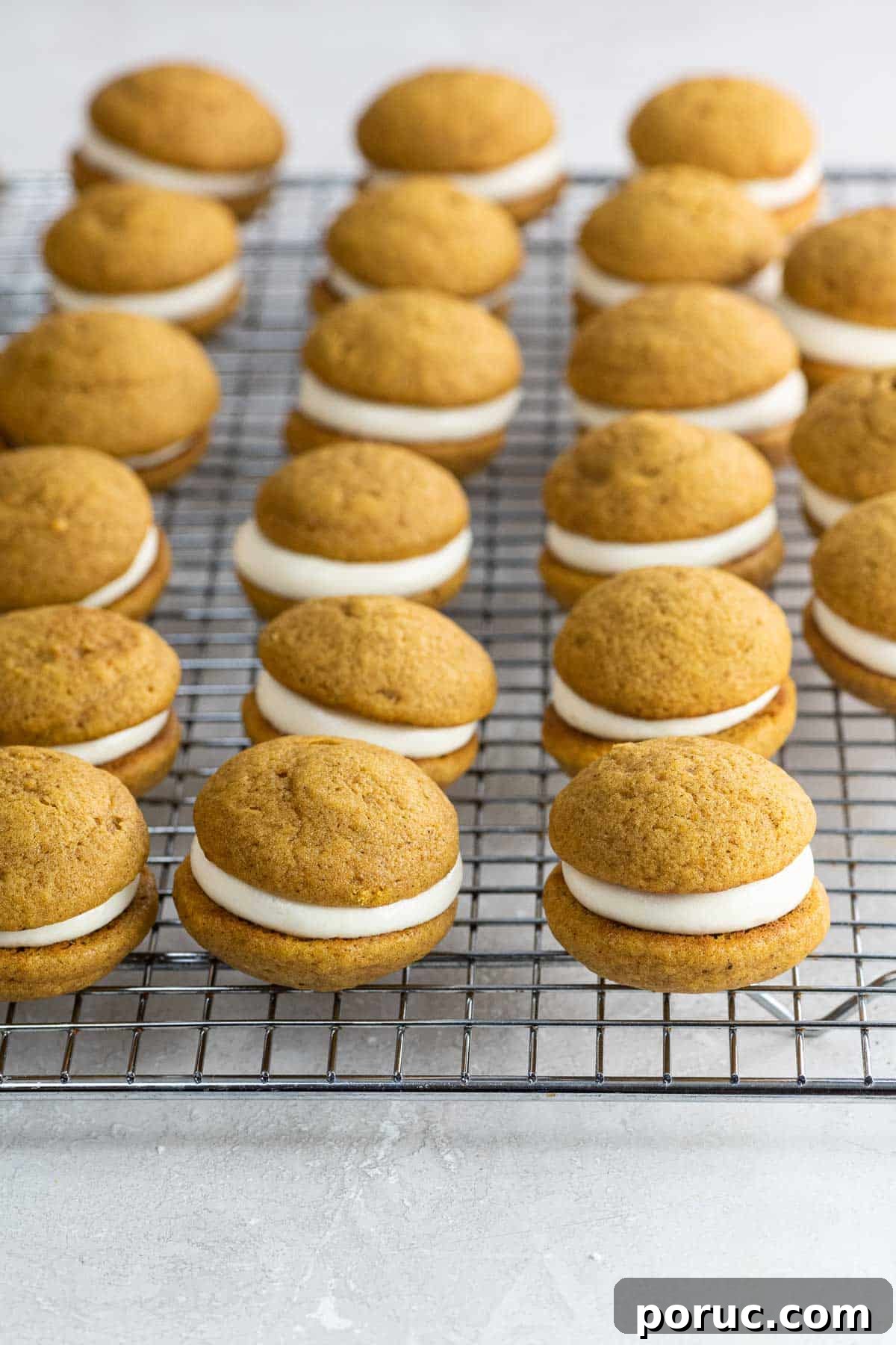 Mini Pumpkin Whoopie Pies with Cream Cheese Filling — Fall Dessert Recipe 7 mini pumpkin whoopie pies on a cooling rack