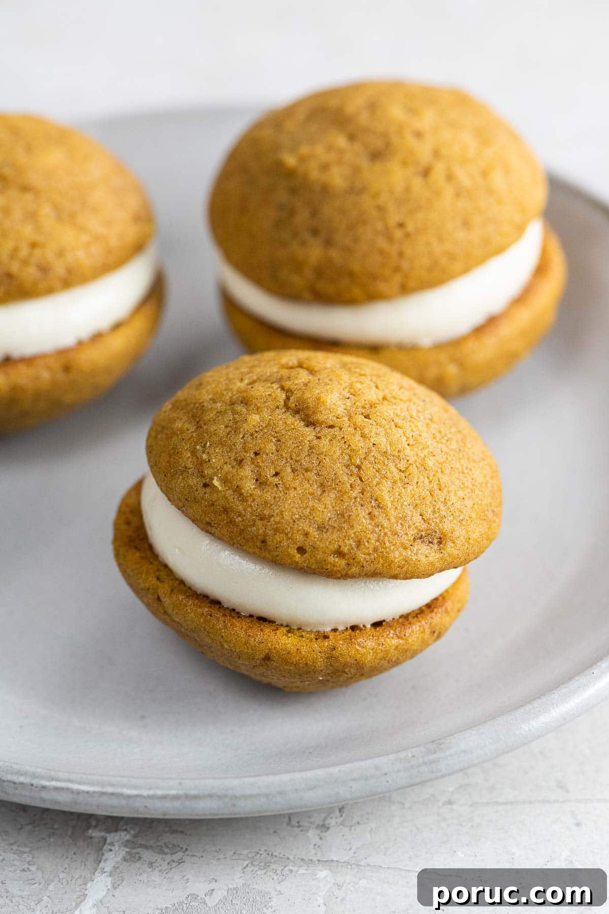 Mini Pumpkin Whoopie Pies with Cream Cheese Filling — Fall Dessert Recipe 8 mini pumpkin whoopie pies on a small plate