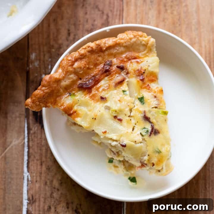 A hearty quiche made up of sliced potatoes, crispy pieces of bacon, green onion and a delicious cheesy sauce.