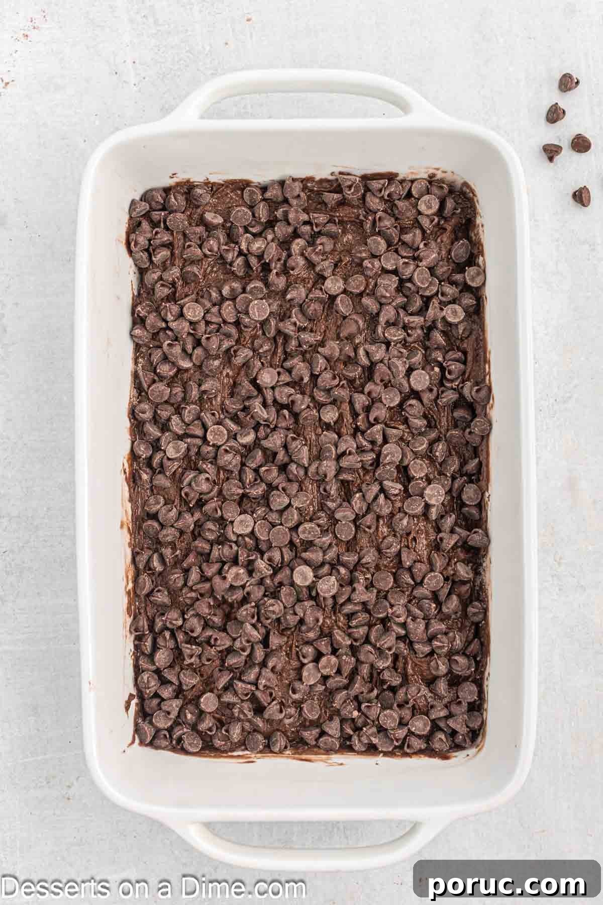 Decadent Chocolate Dump Cake Recipe for Quick Desserts 6 Chocolate chips spread on top of cake mix.