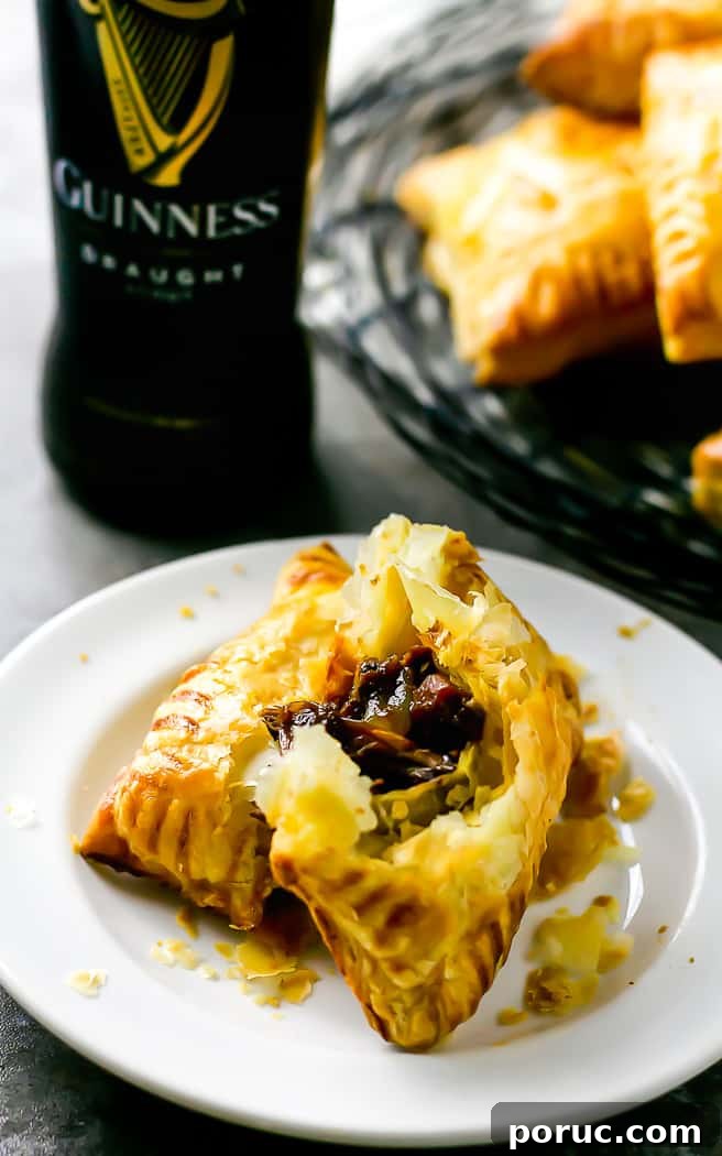 Mini Steak and Ale Hand Pies: Savory Individual Meat Pies 10 plate with savory hand pie torn in half