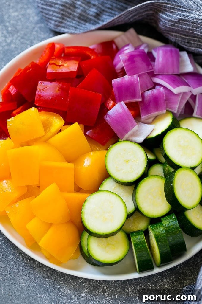 Vegetables for Kabobs Zucchini, red peppers, yellow peppers and red onion for grilled chicken skewers.