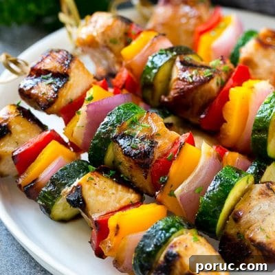 Flavorful Grilled Chicken Kabobs with Mediterranean Marinade 2 A plate of grilled chicken kabobs made with marinated chicken and colorful vegetables.