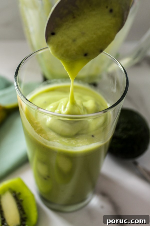 Creamy Kiwi Avocado Smoothie Recipe for a Refreshing Breakfast 4 A thick, creamy green kiwi banana smoothie in a glass.