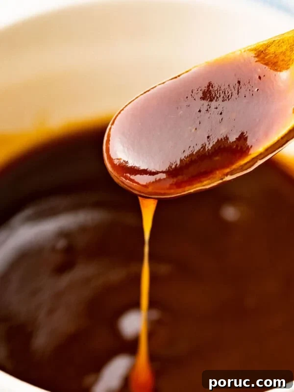 Tonkatsu sauce flowing off a spoon.