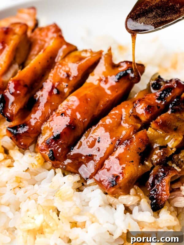Chicken teriyaki glazed with sauce with steamed rice.