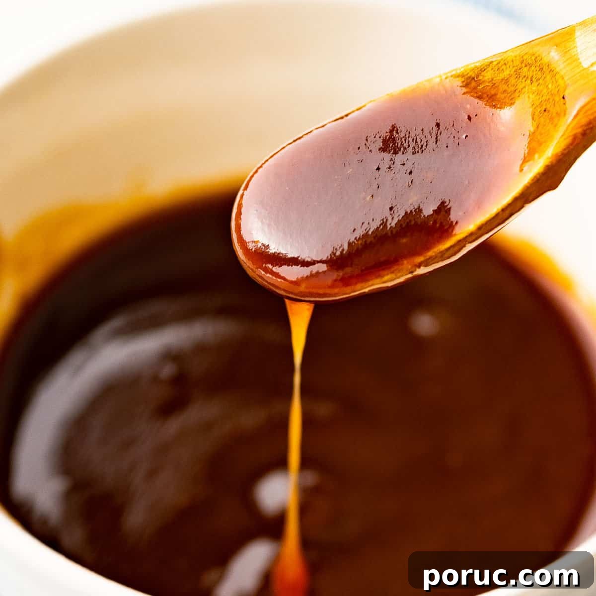 Katsu sauce flowing off a spoon.
