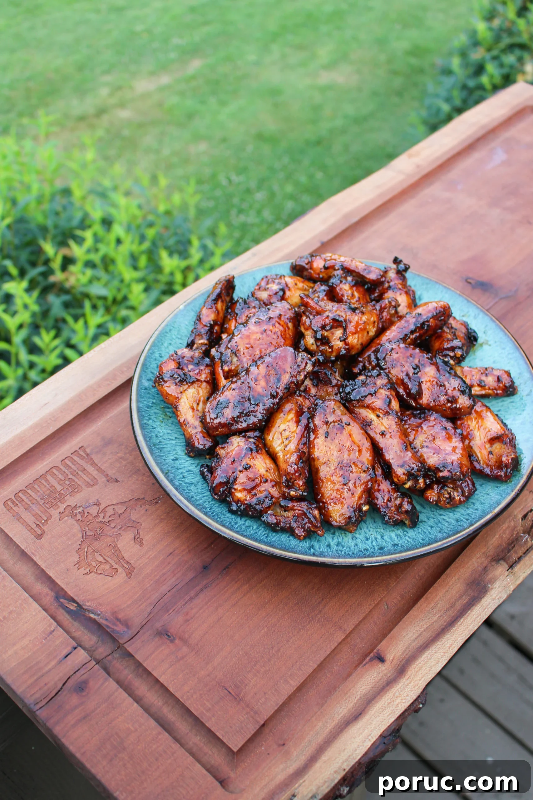 Crispy Baked Peach-Glazed Chicken Wings 3 Maple Peach Sticky sitting on a cutting board.