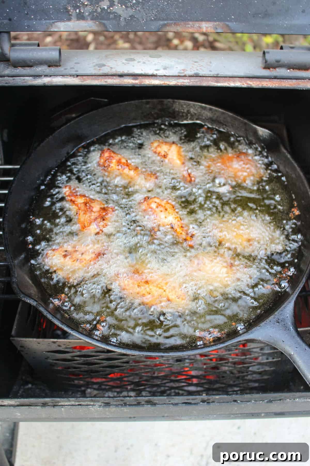 Crispy Baked Peach-Glazed Chicken Wings 7 The frying chicken wings in the oil over the charcoal.