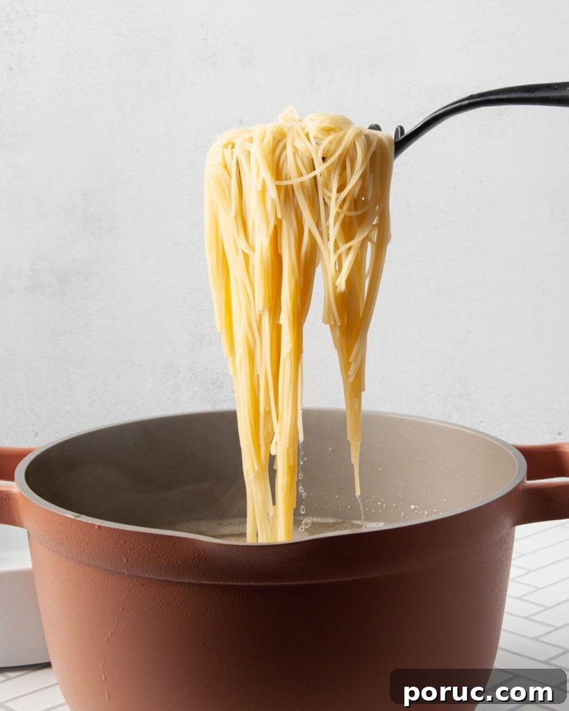 One-Pot Mushroom Pesto Pasta with 4 Ingredients 4 Using pasta server to remove noodles from water.
