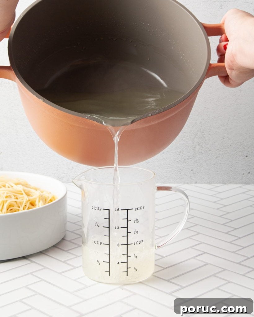 One-Pot Mushroom Pesto Pasta with 4 Ingredients 5 Pouring pasta water into measuring cup.