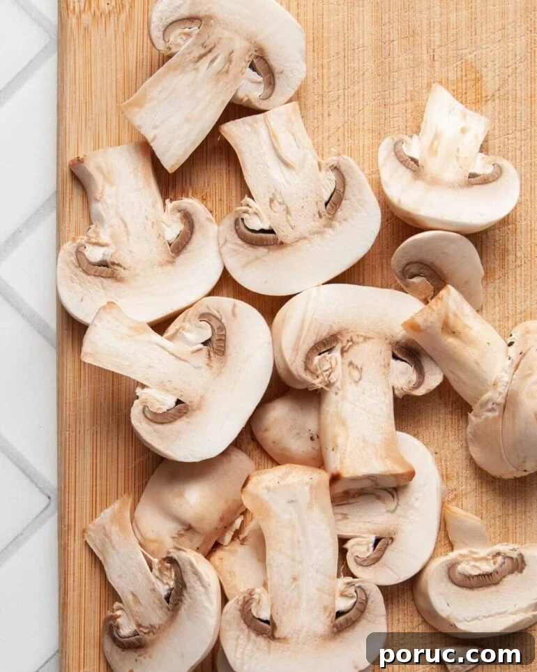 One-Pot Mushroom Pesto Pasta with 4 Ingredients 6 Slicing mushrooms for mushroom pesto pasta.