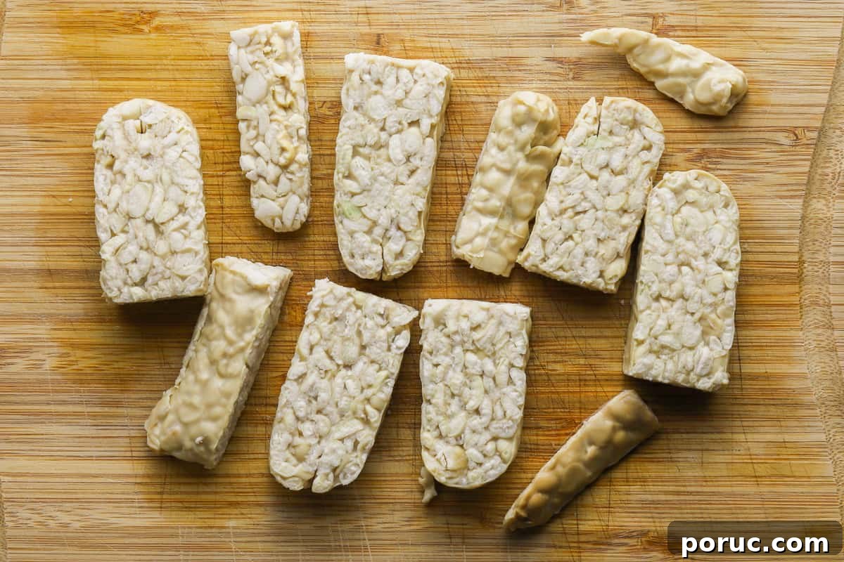 Chinese-Style Green Beans with Crispy Tempeh (Vegan Recipe) 3 photo of pieces of tempeh on a chopping board