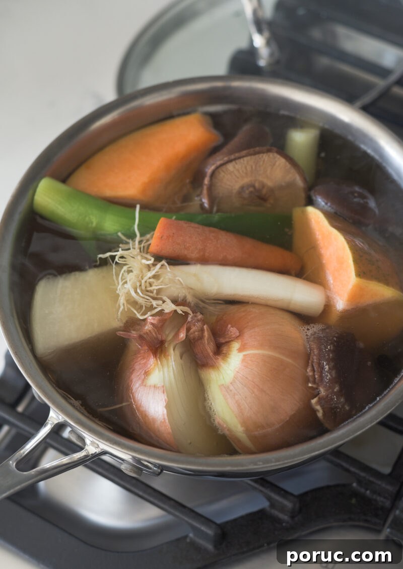 5 Essential Korean Soup Stocks for Authentic Korean Cooking 15 A pot of vegetable stock is simmering with various vegetables and mushroom.