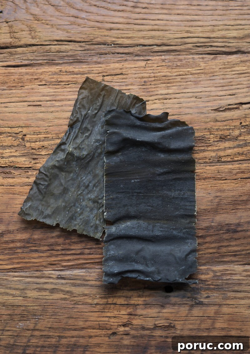 5 Essential Korean Soup Stocks for Authentic Korean Cooking 5 Two pieces of dried sea kelp are placed on a wooden board.