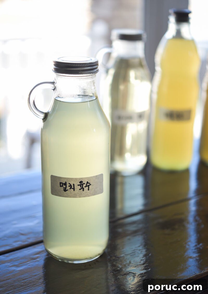 5 Essential Korean Soup Stocks for Authentic Korean Cooking 7 Anchovy stock is stored in a glass bottle with a label written in Korean.