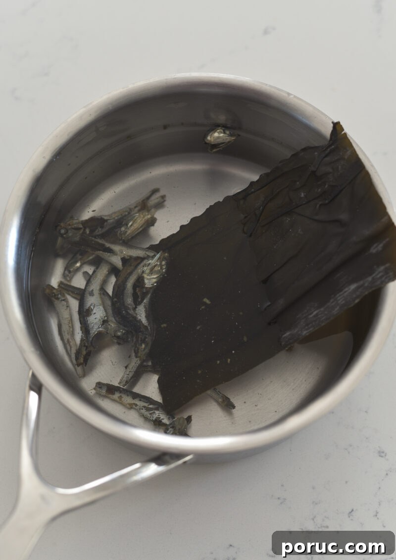 5 Essential Korean Soup Stocks for Authentic Korean Cooking 9 Dried anchovies and sea kelps are combined with water in a pan.
